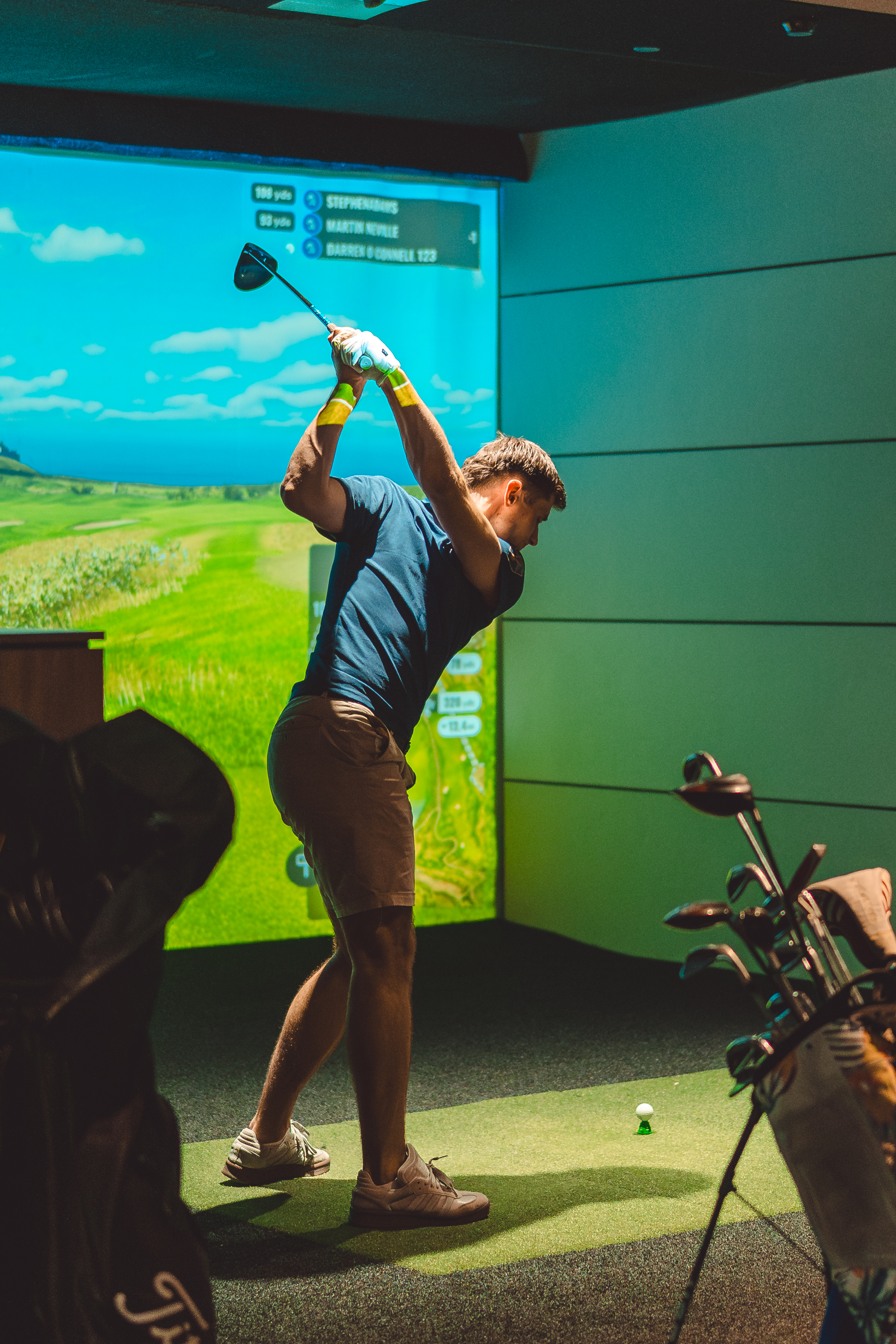 Golfer taking a swing on simulator